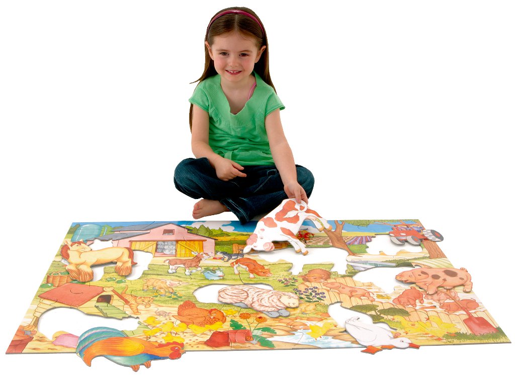 Girl making giant floor puzzle